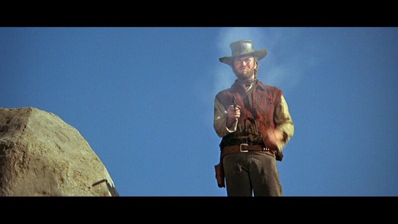 man in cowboy hat holding gun