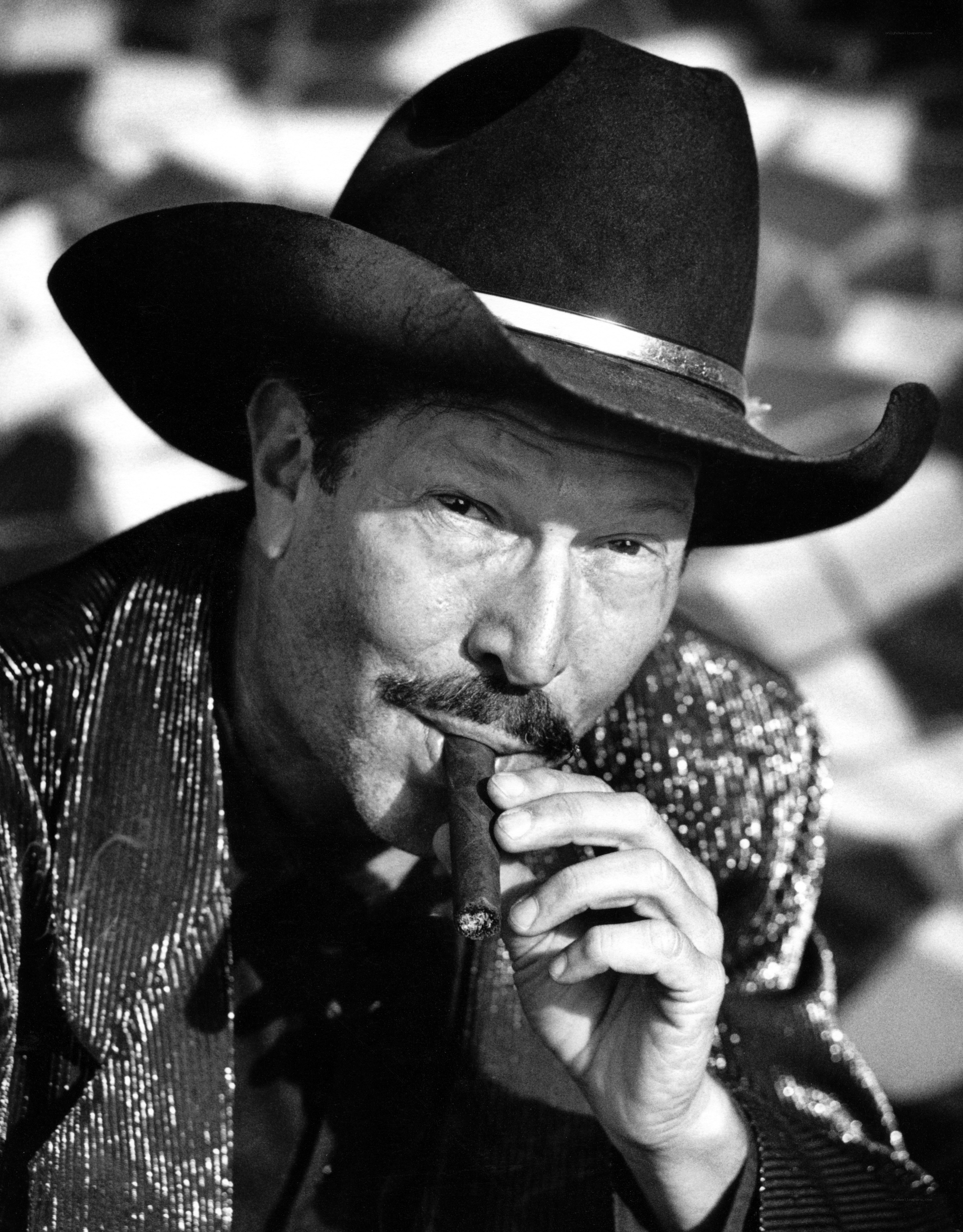 Man in cowboy hat smoking cigar