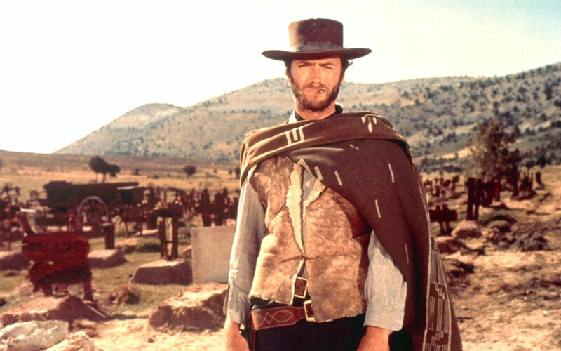 Man in cowboy hat standing in desert