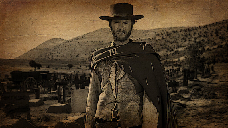Man in cowboy hat stands in desert