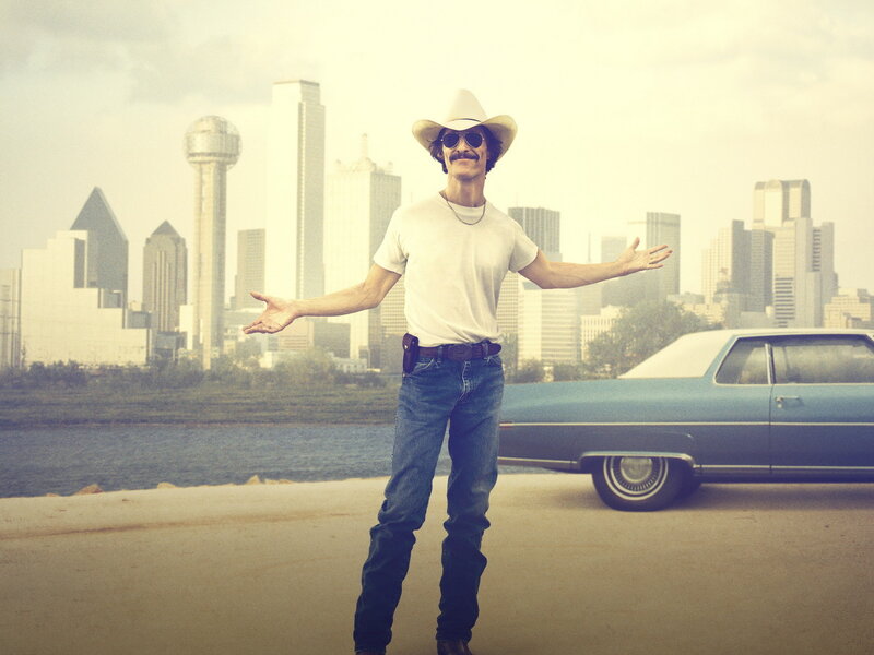 Man in cowboy hat with city backdrop