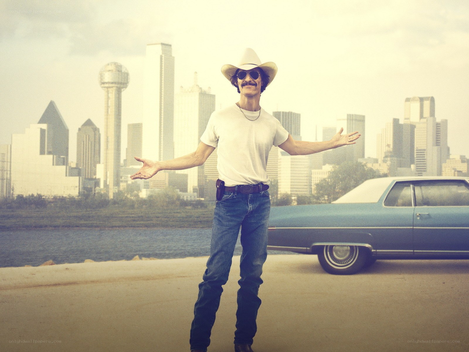 Man in cowboy hat with city backdrop