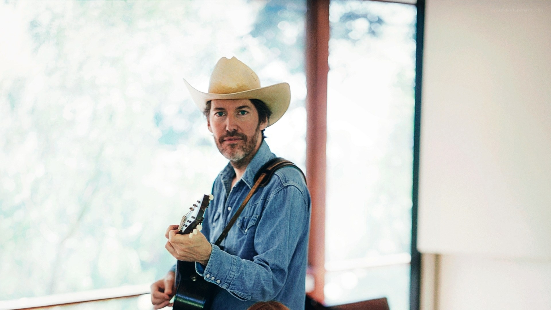 Man in cowboy hat with guitar