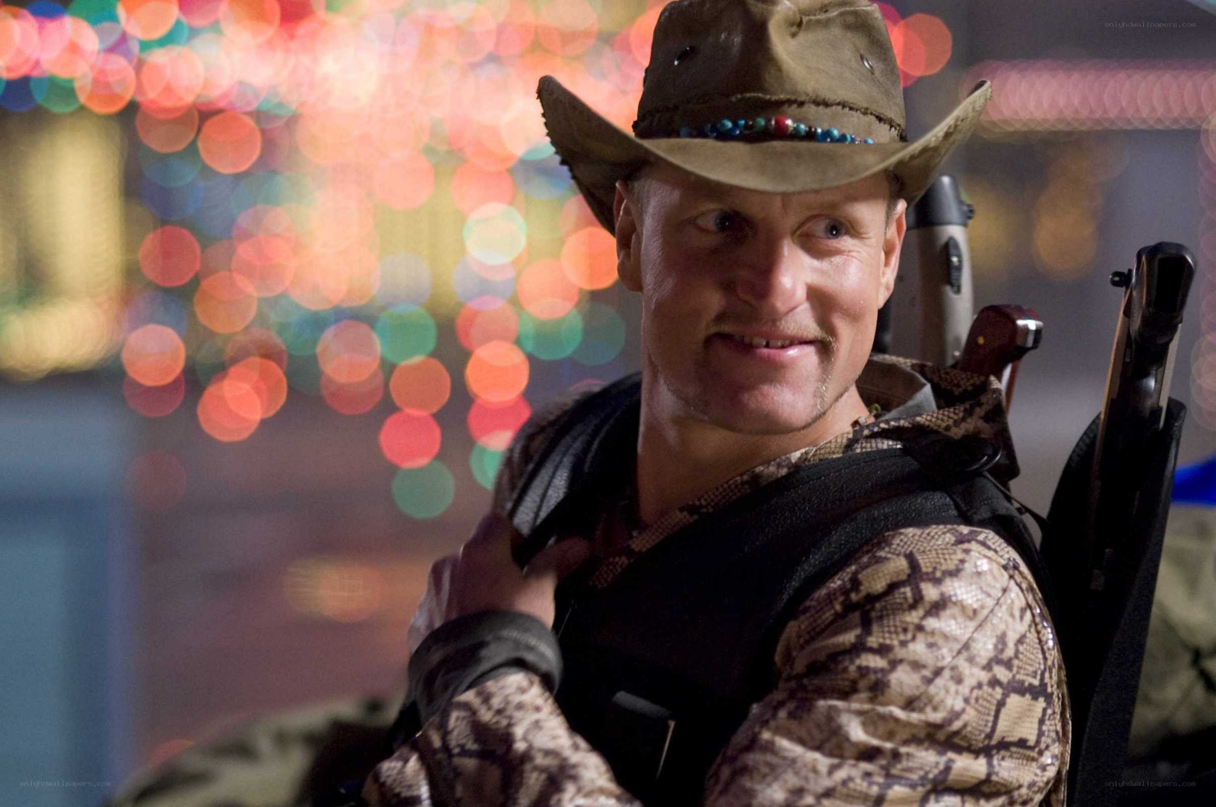 Man in cowboy hat with weapons