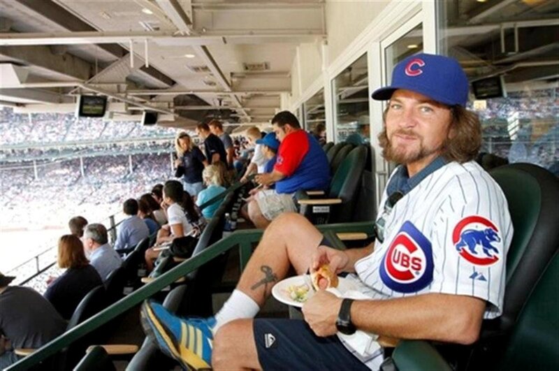Man in Cubs gear at baseball game