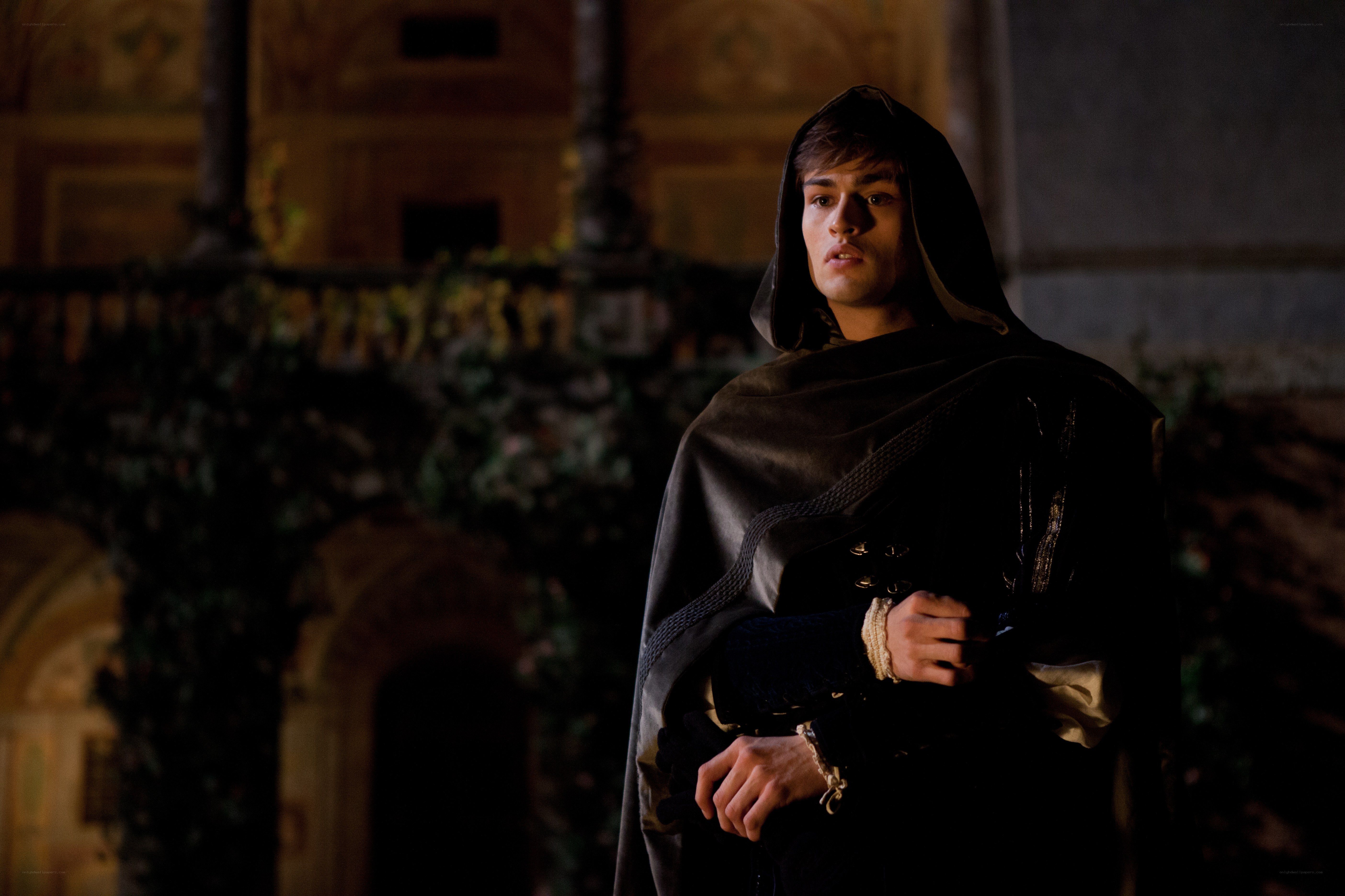 man in dark cloak at night