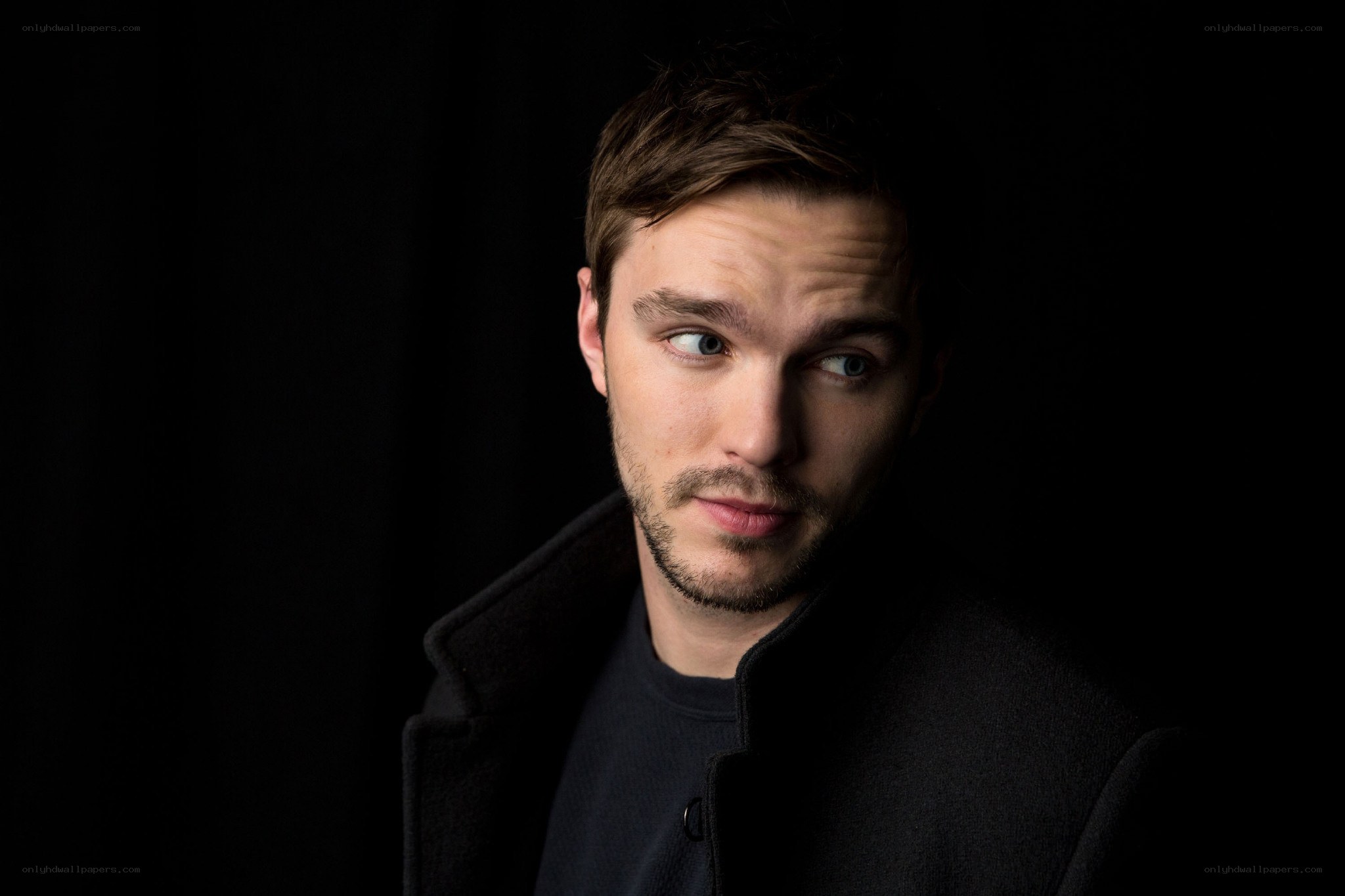 man in dark coat looking sideways