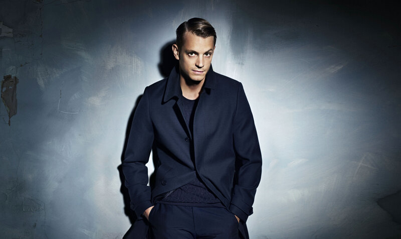 man in dark coat posing