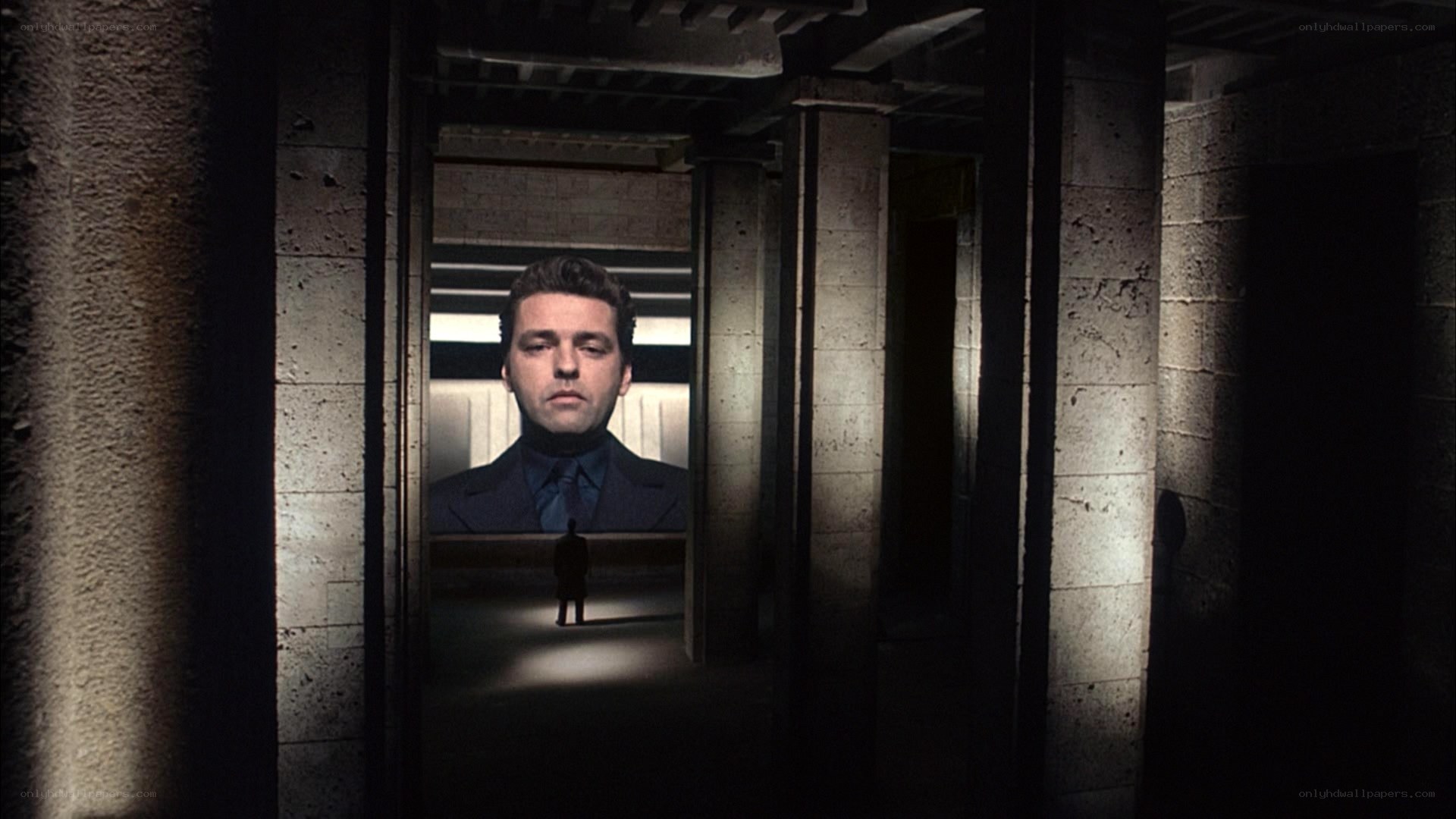 man in dark corridor with portrait