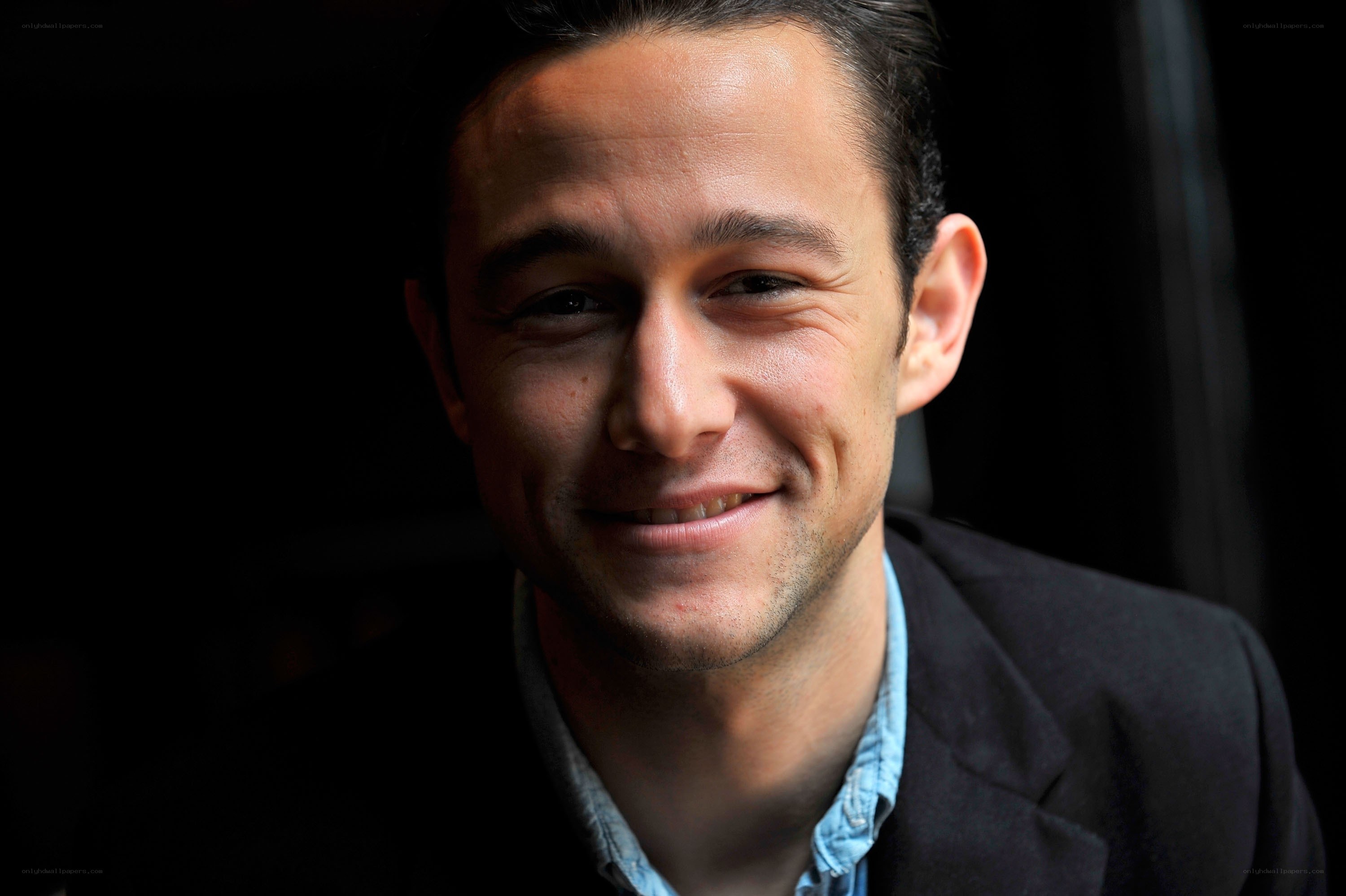 man in dark jacket smiling
