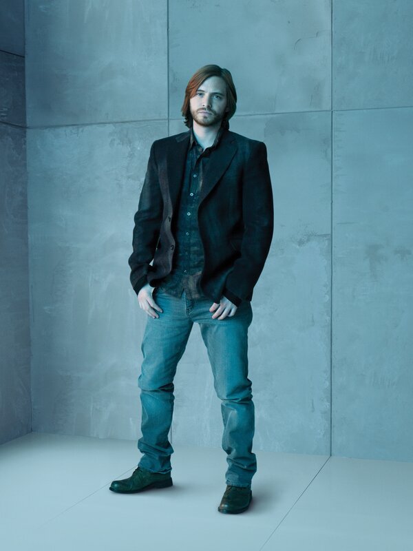 man in dark jacket standing