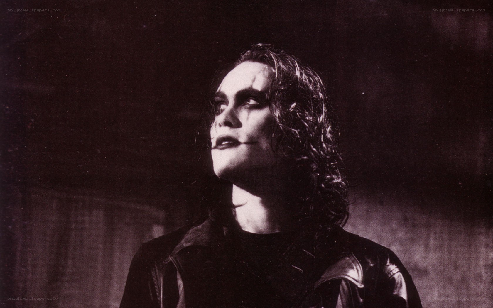 man in dark makeup looking up