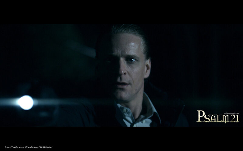 man in dark room with flashlight