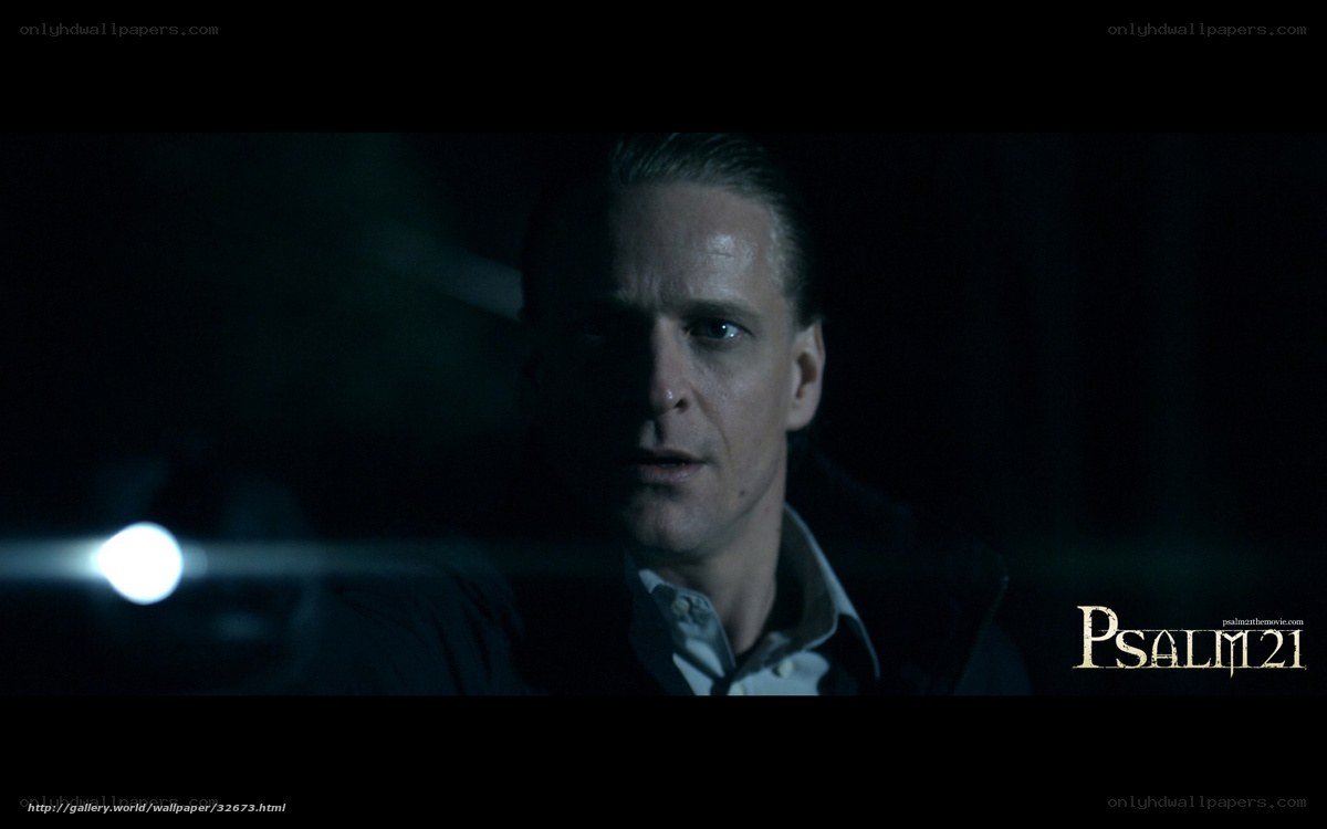 man in dark room with flashlight