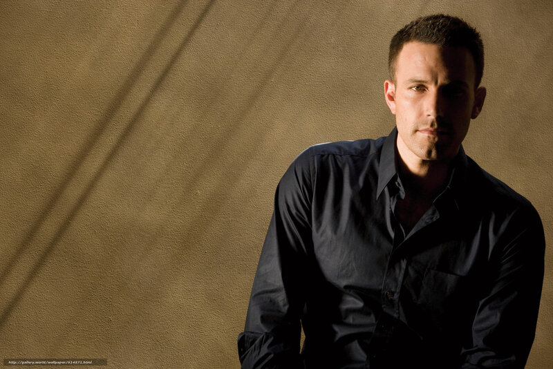 Man in dark shirt against wall