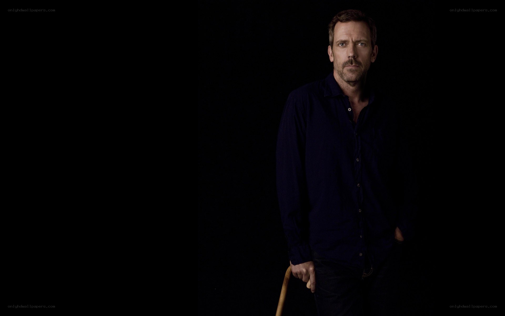 man in dark shirt holding cane
