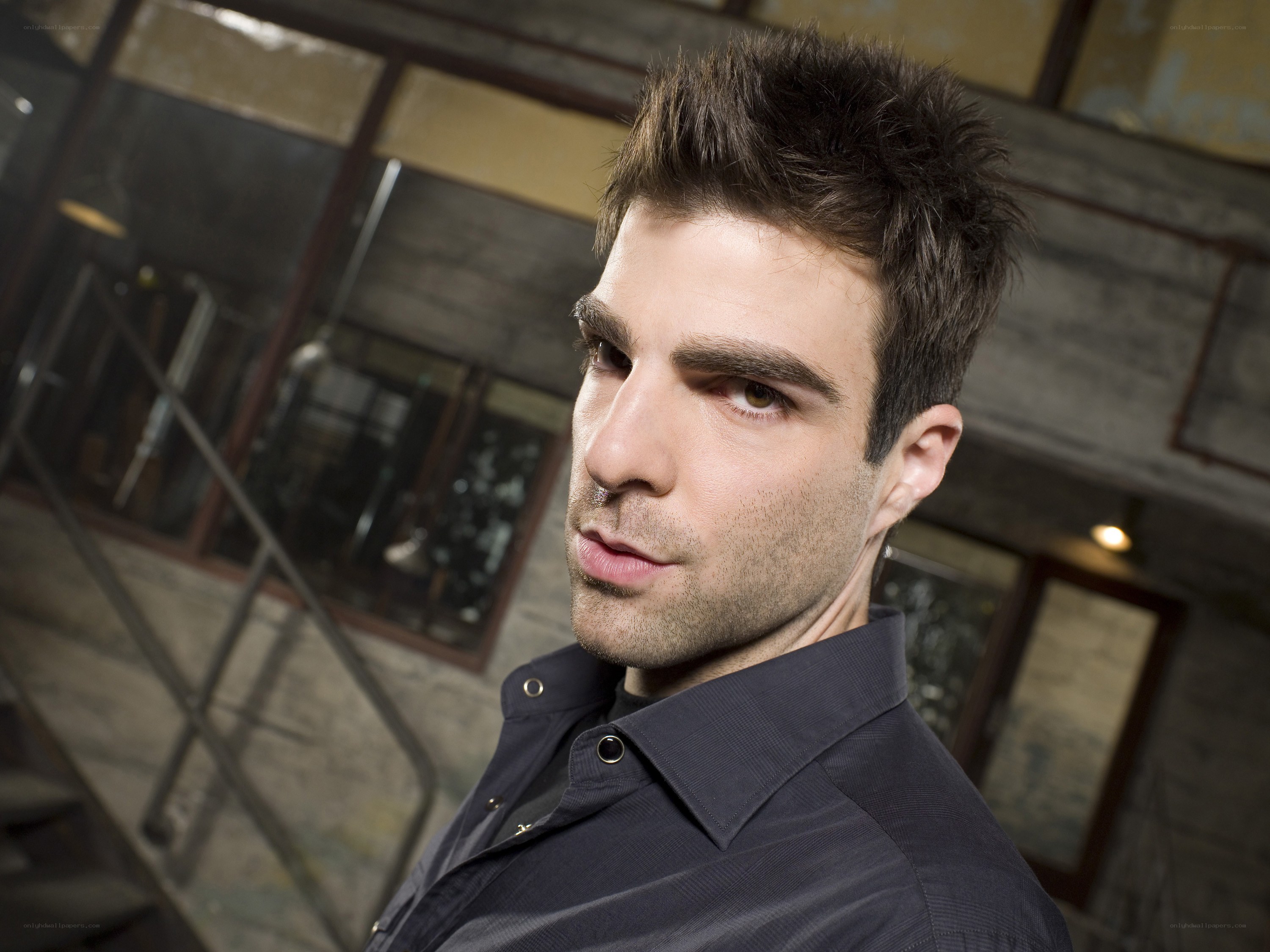 man in dark shirt looking at camera