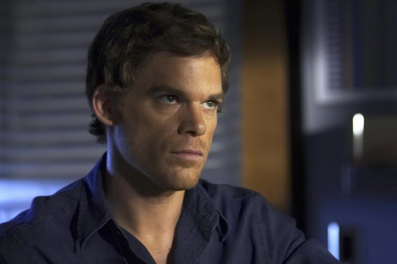 man in dark shirt looking serious