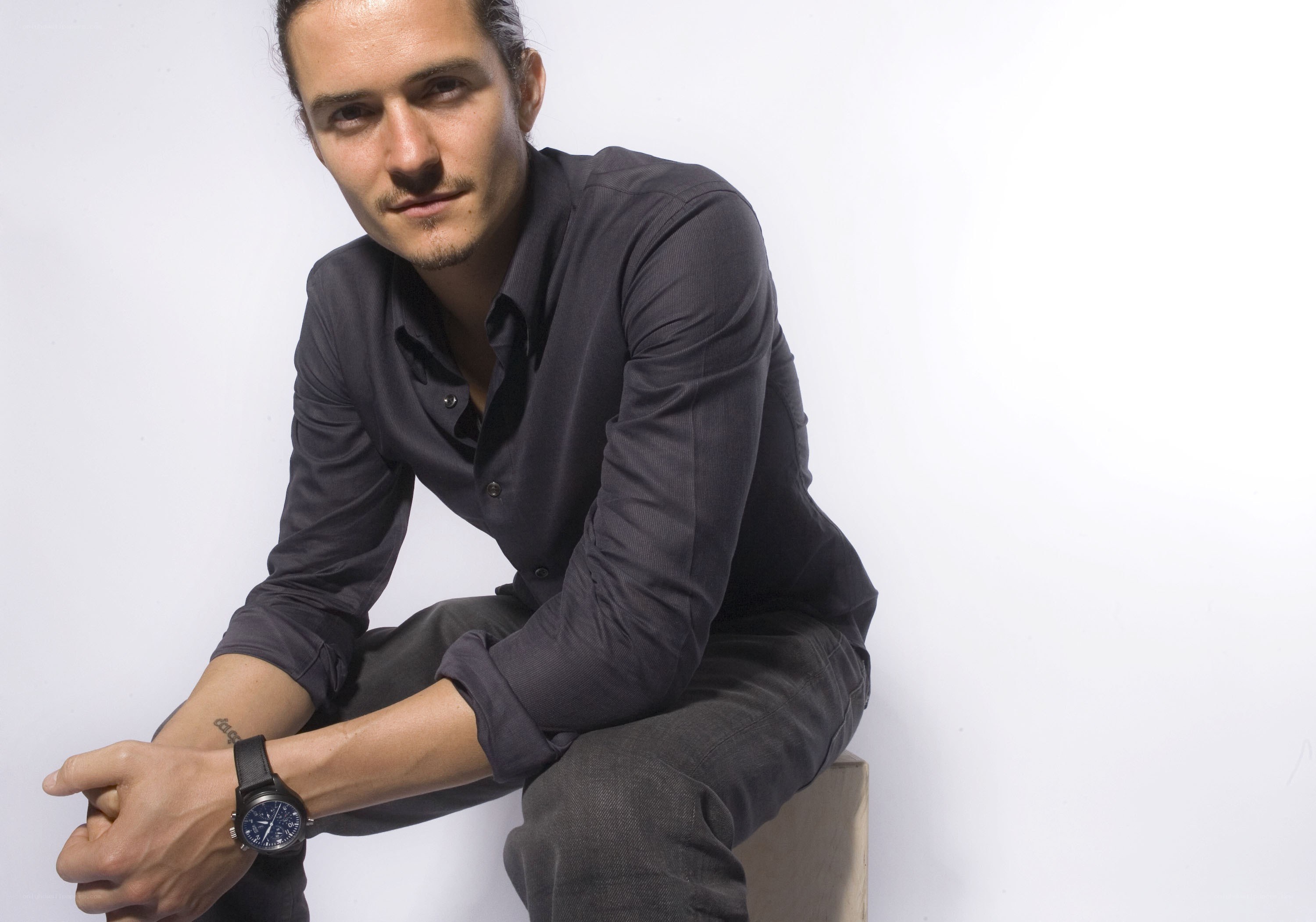 man in dark shirt sitting
