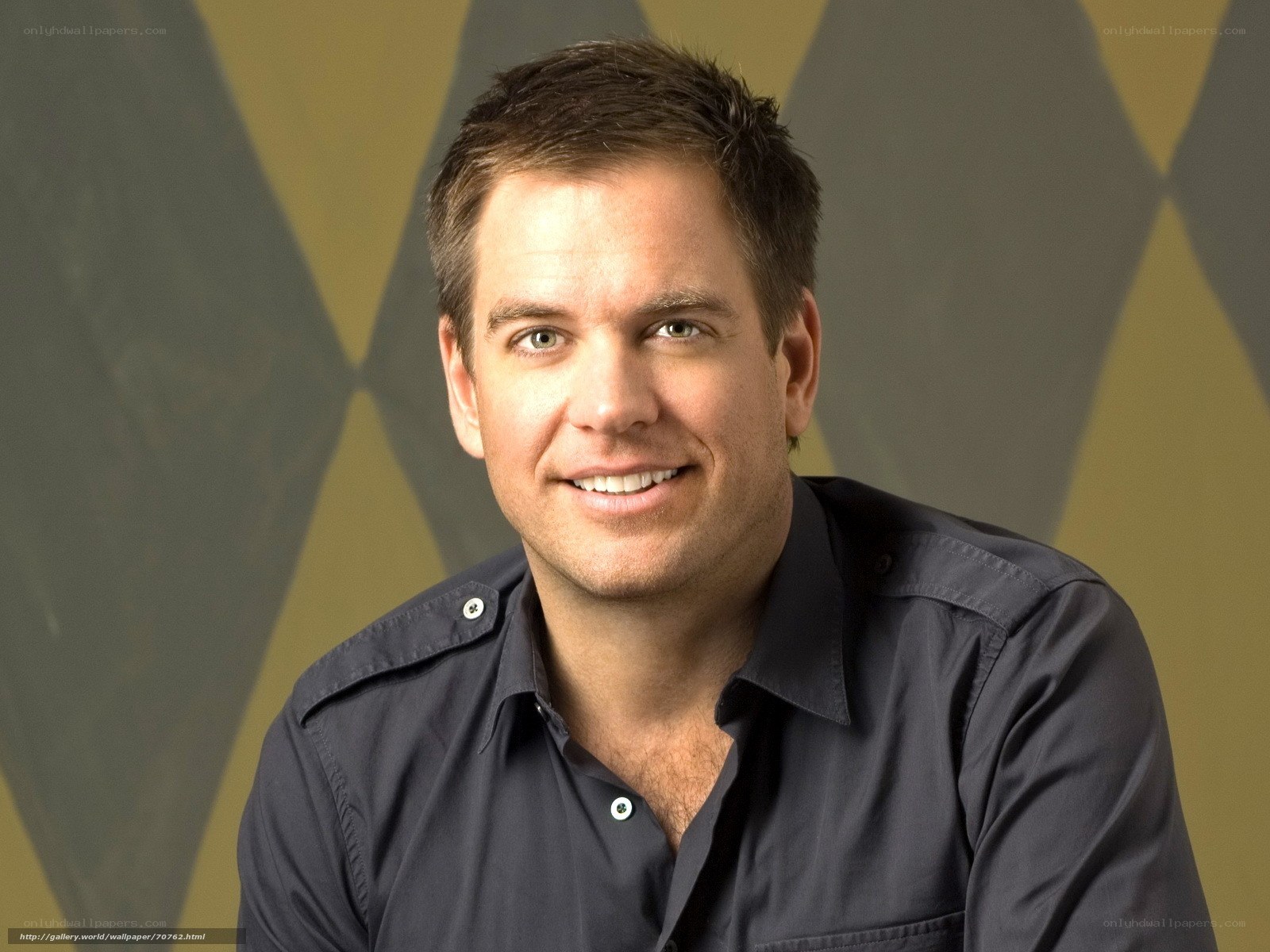 man in dark shirt smiling