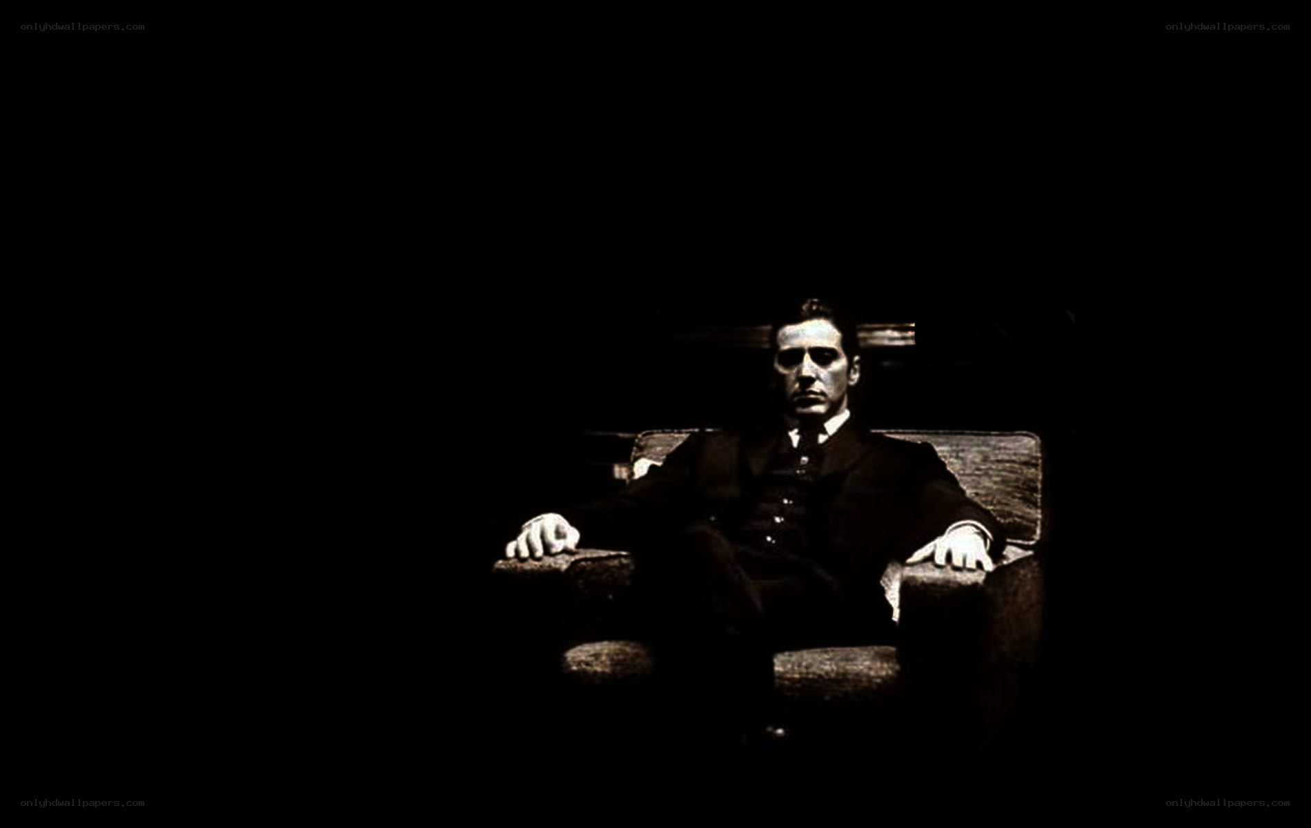 man in dark suit sitting