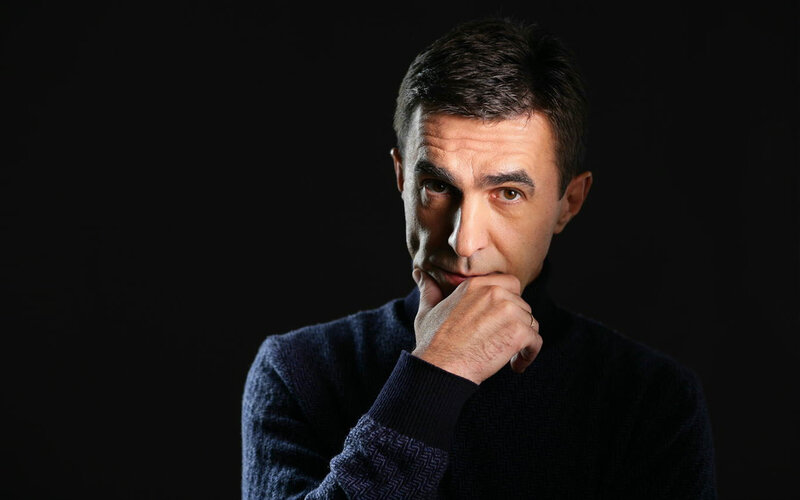man in dark sweater thinking