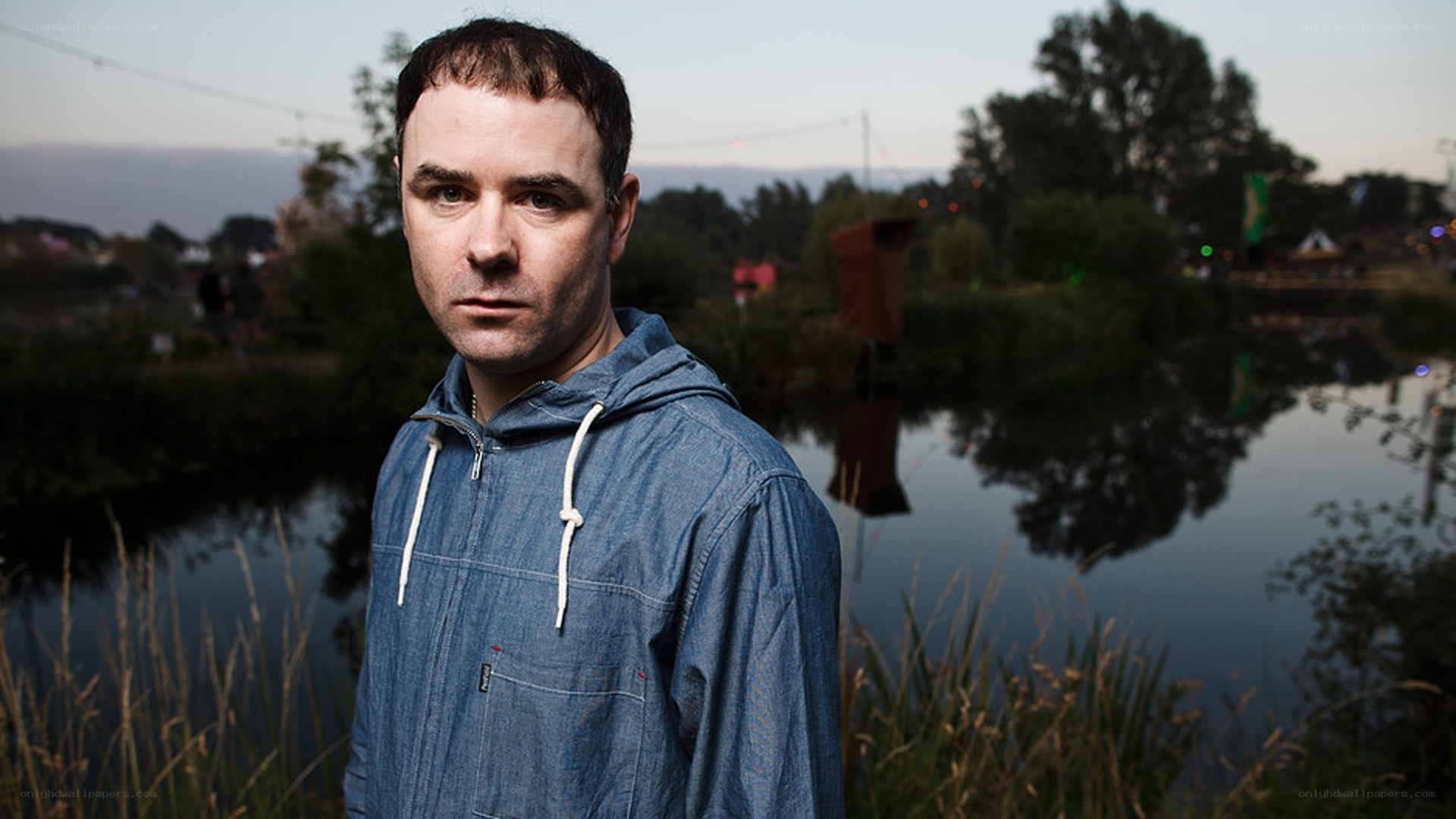 Man in denim hoodie by water