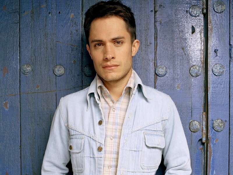 Man in Denim Jacket — Blue, Neutral, Photograph, Wooden Door