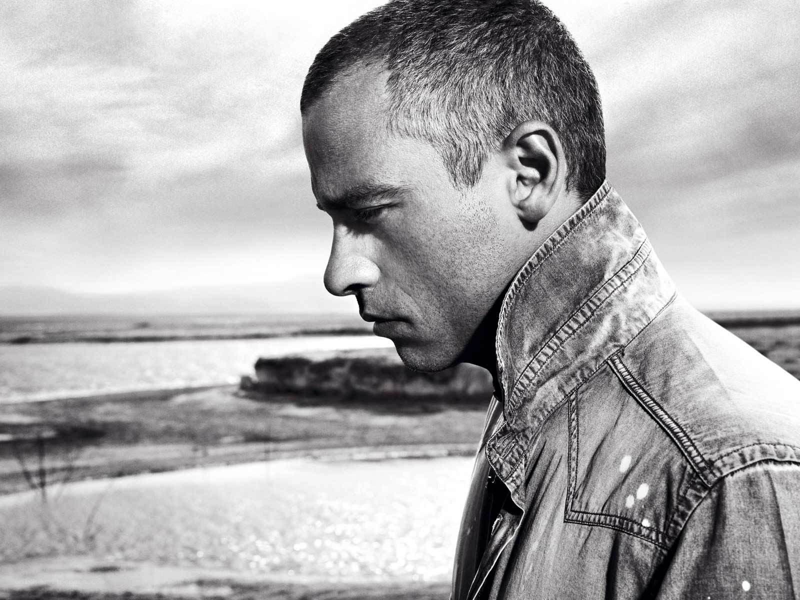man in denim jacket by water