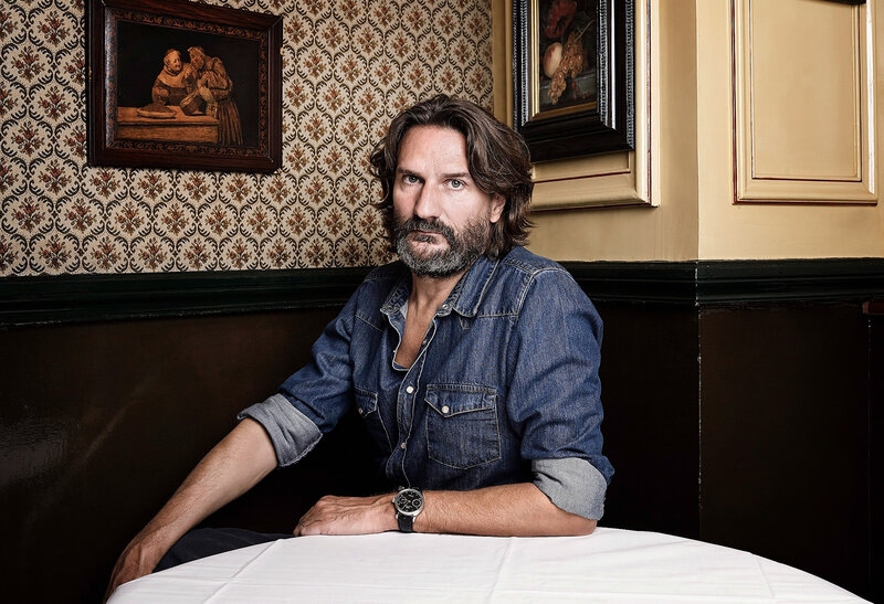 Man in denim shirt at table
