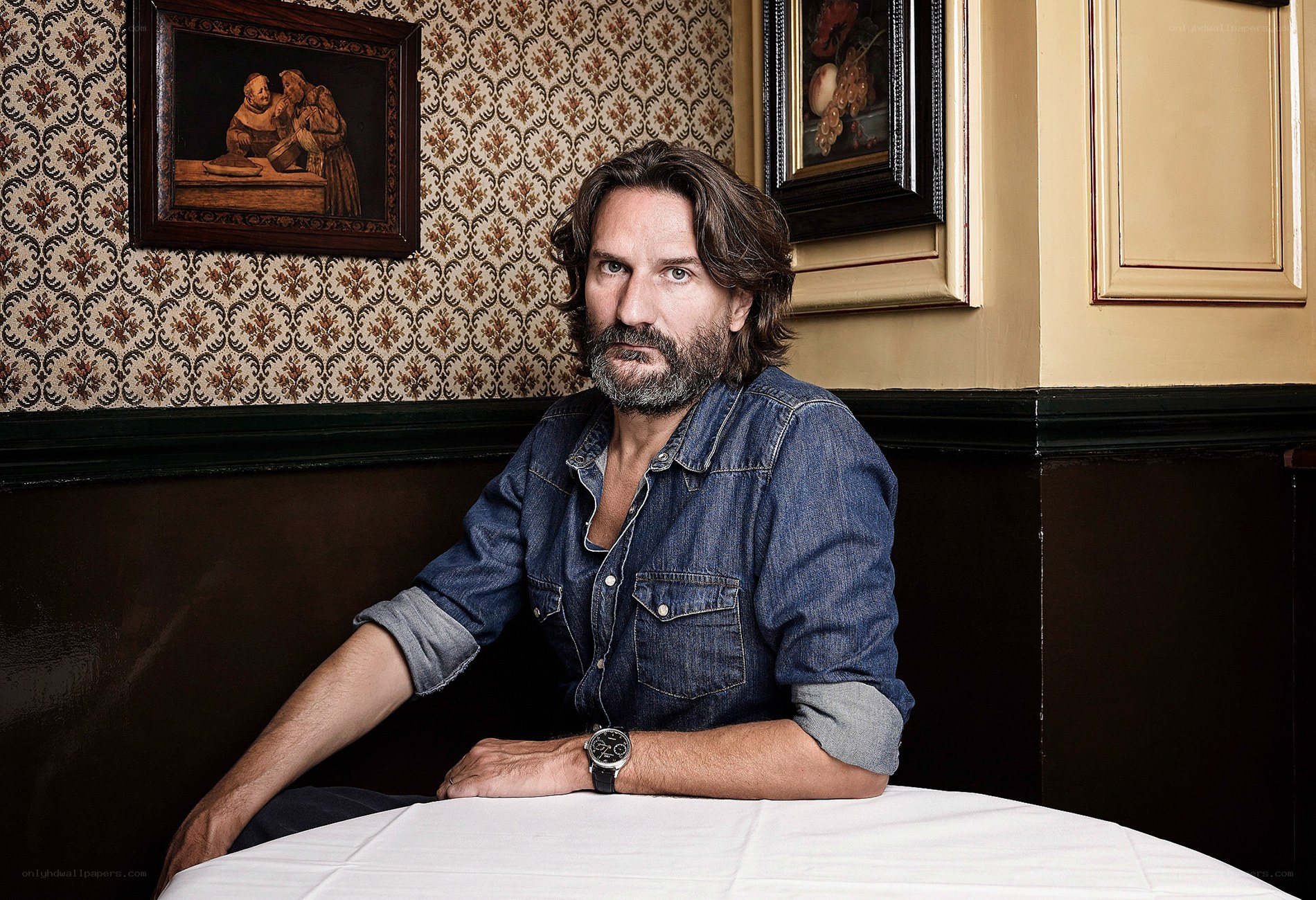 Man in denim shirt at table