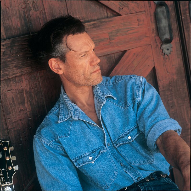 man in denim shirt leaning