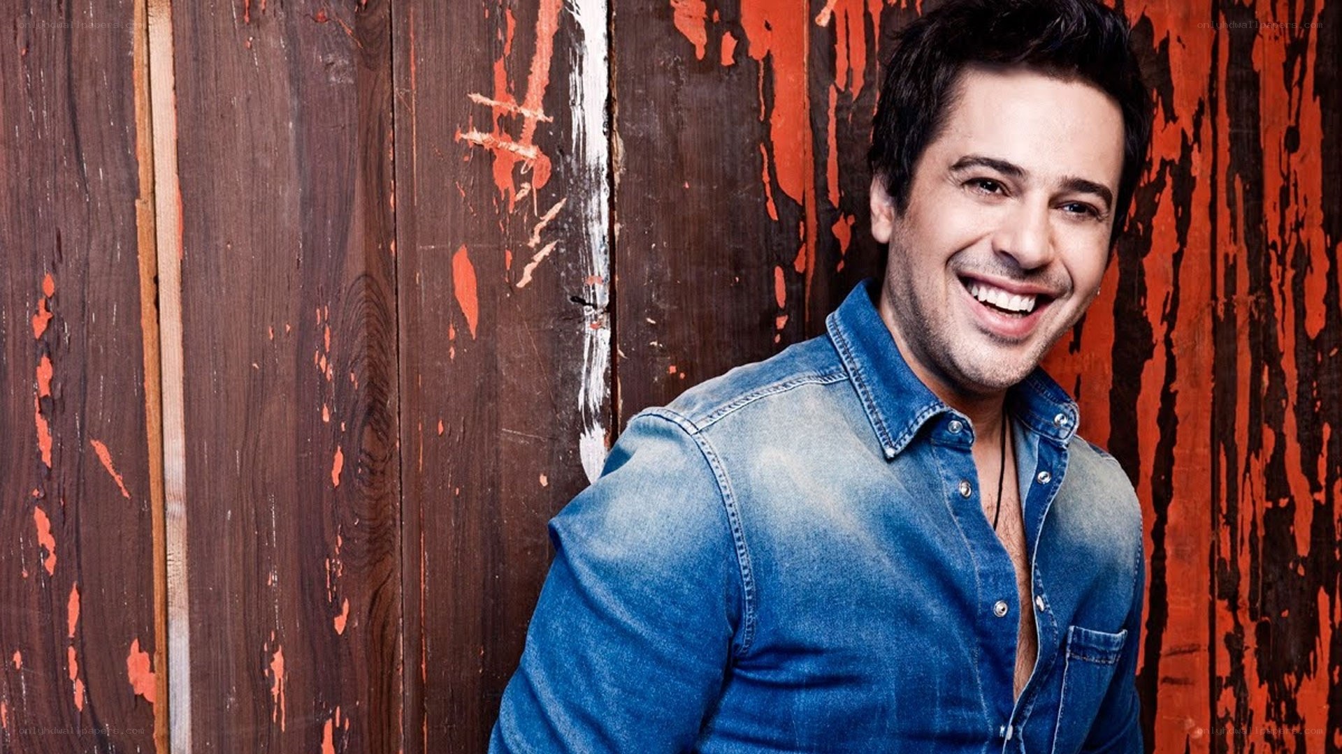man in denim shirt smiling