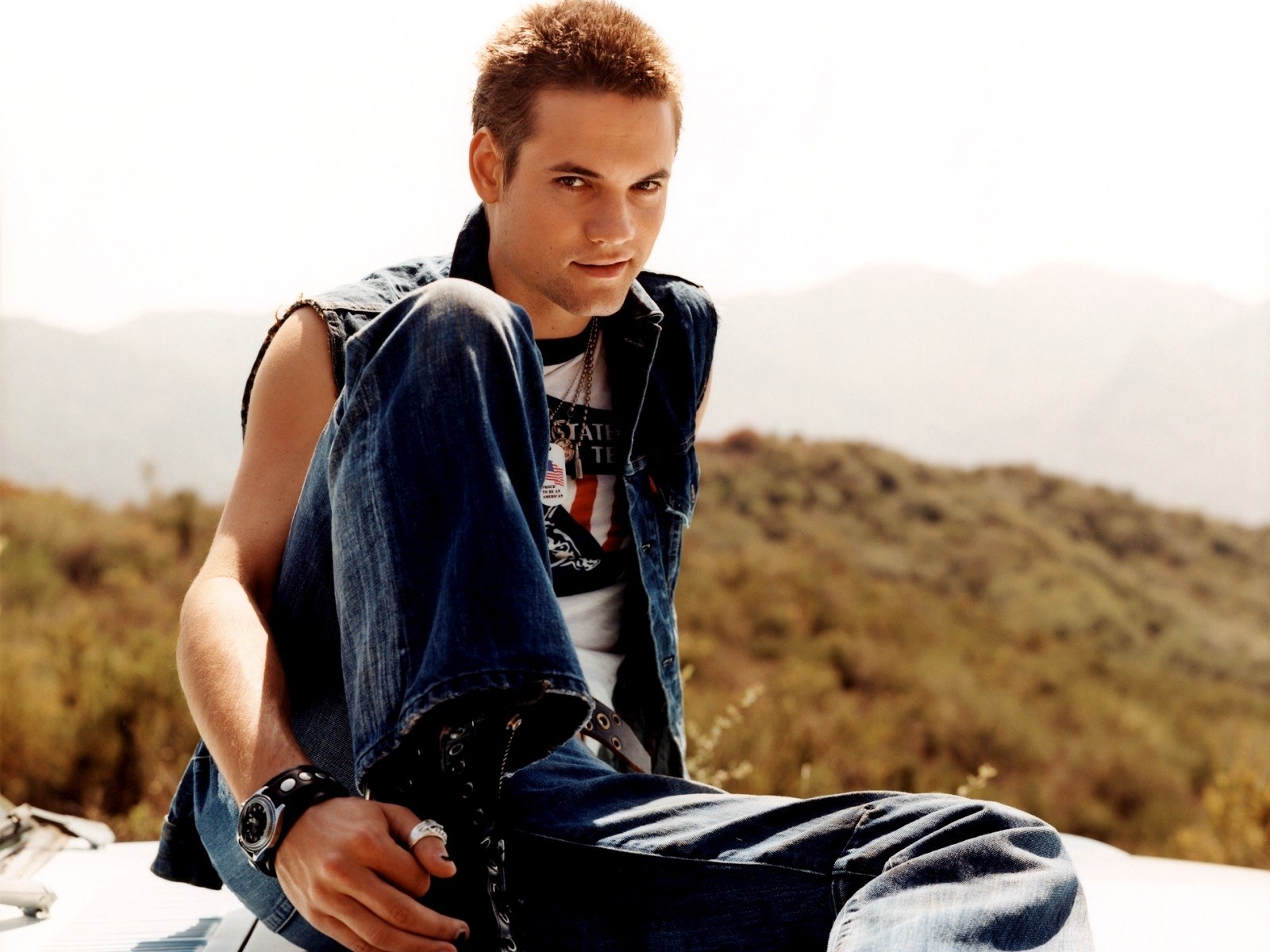 man in denim vest outdoors
