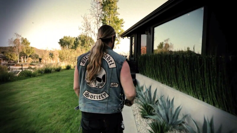 man in denim vest walking