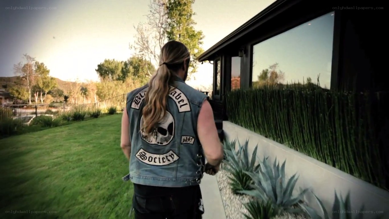 man in denim vest walking