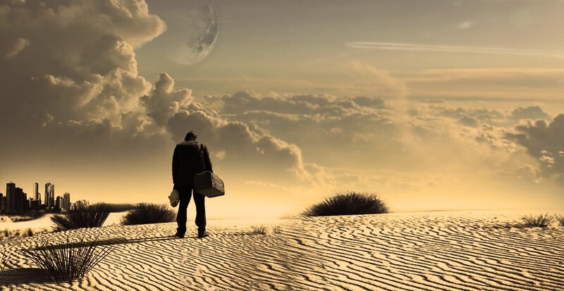 man in desert with city view
