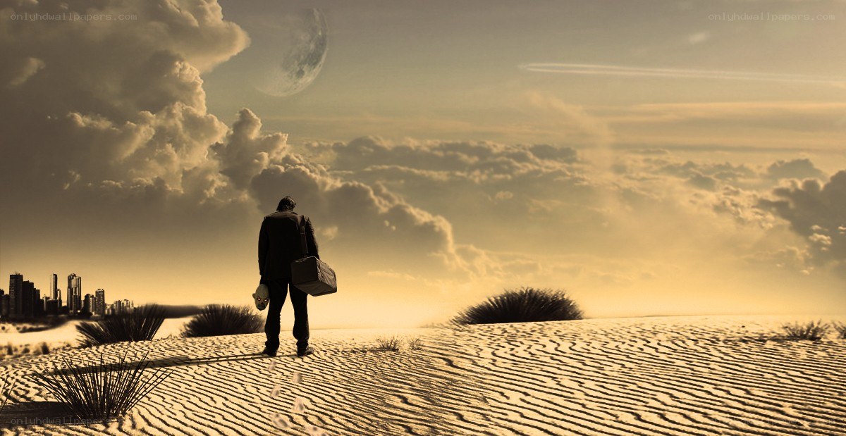 man in desert with city view