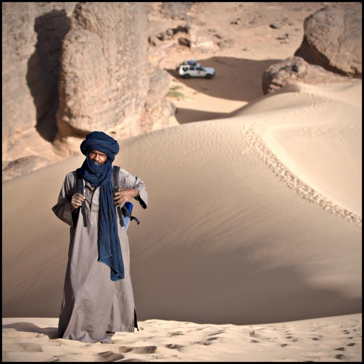 Man in desert with vehicle