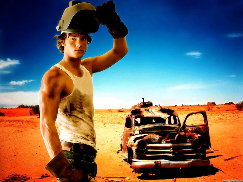 man in desert with wrecked car