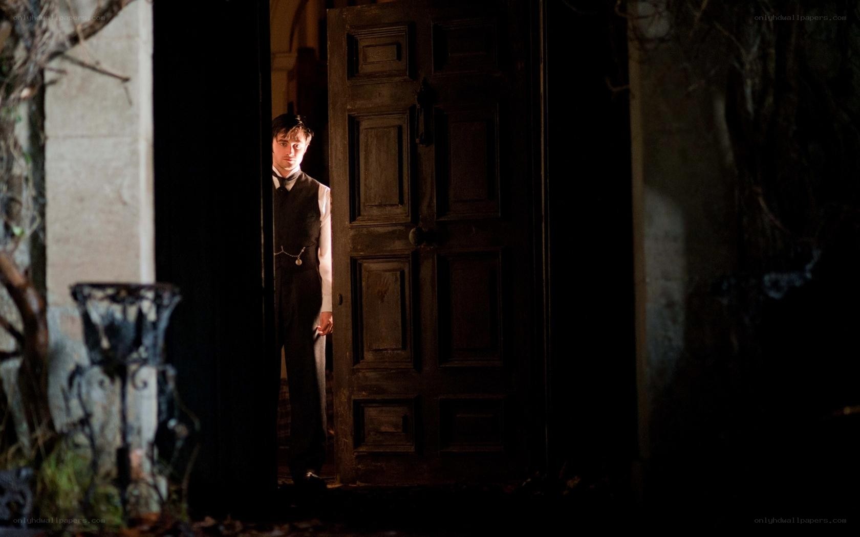 man in doorway at night