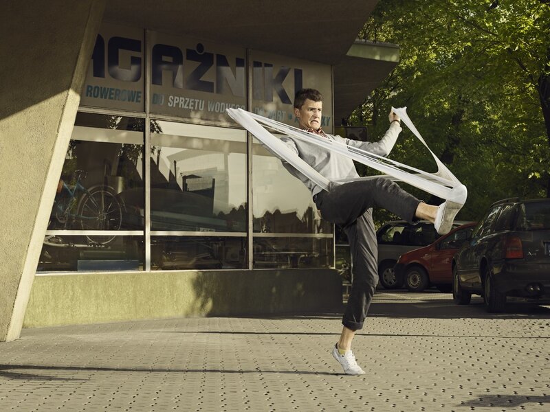 Man in dynamic pose with fabric