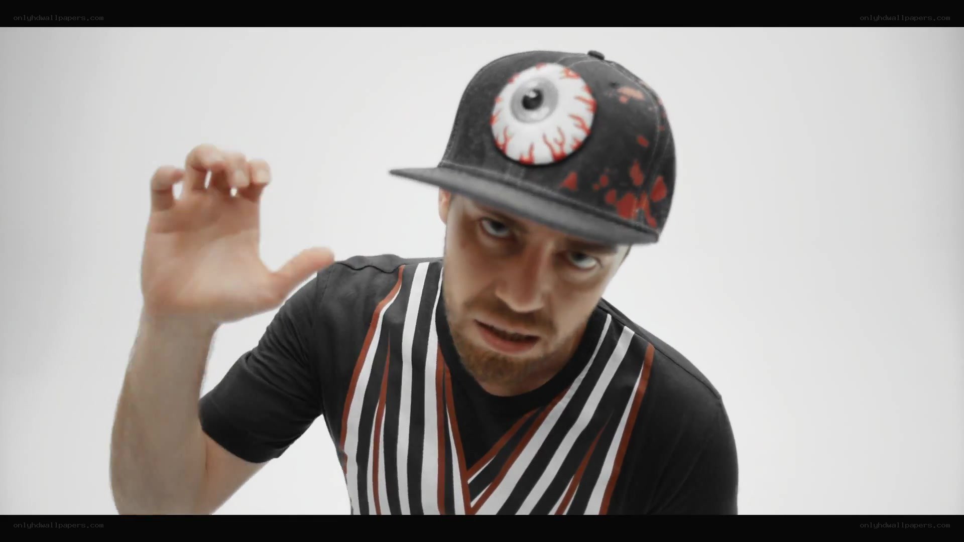 man in eye hat gesturing
