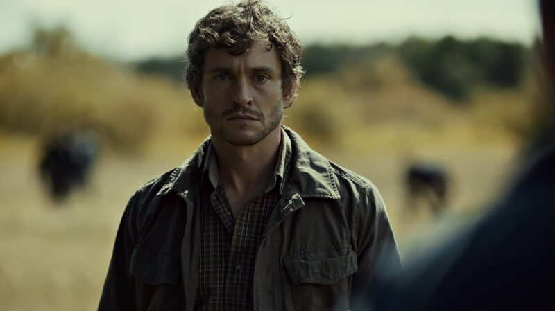 man in field looking at camera
