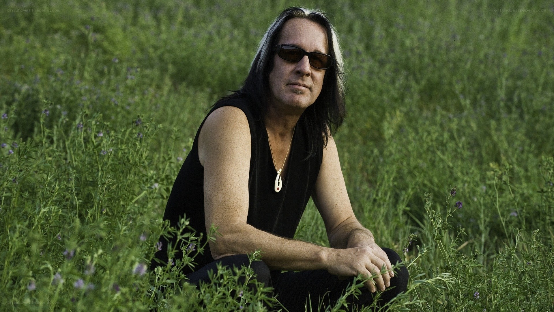 man in field with sunglasses