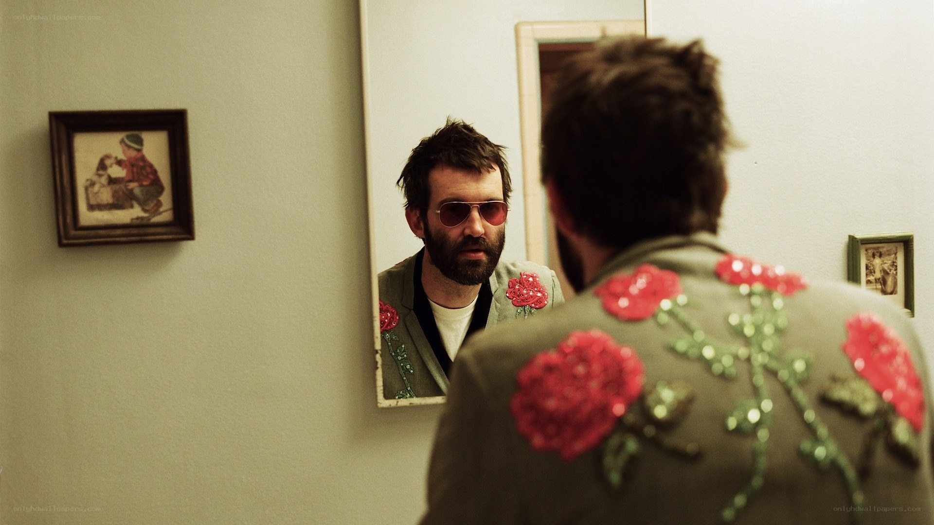 man in floral jacket looking in mirror