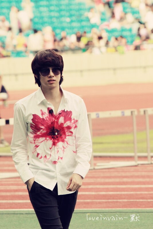 man in floral shirt at stadium
