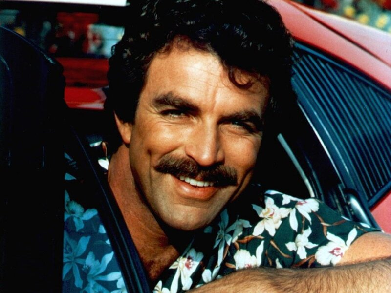 man in floral shirt smiling