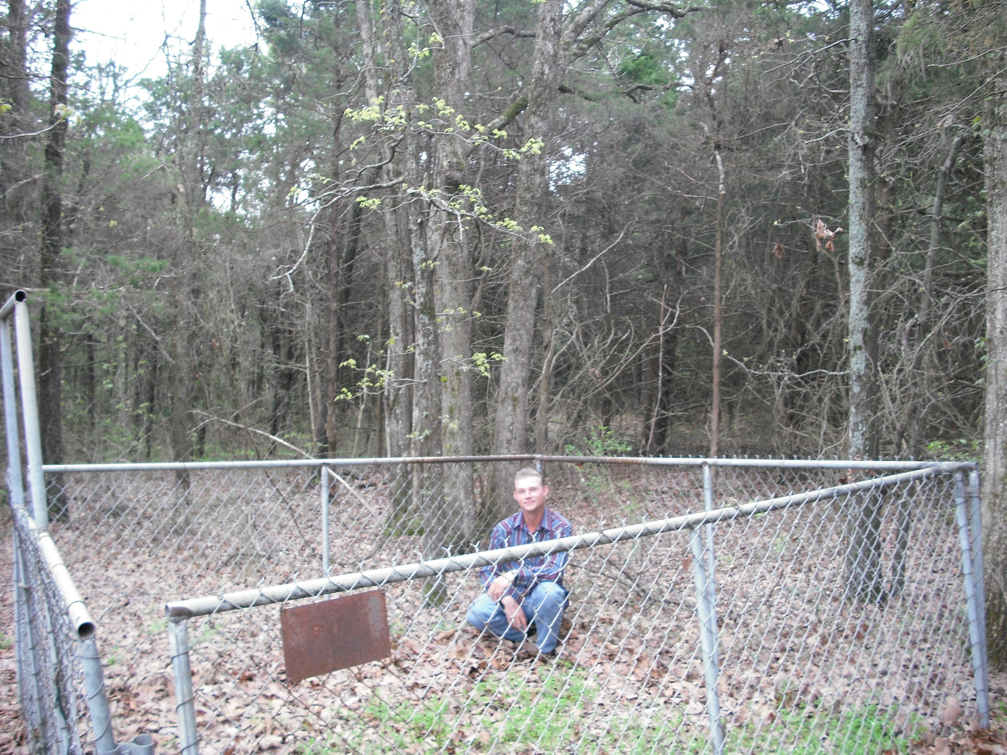 Man in forest near fence