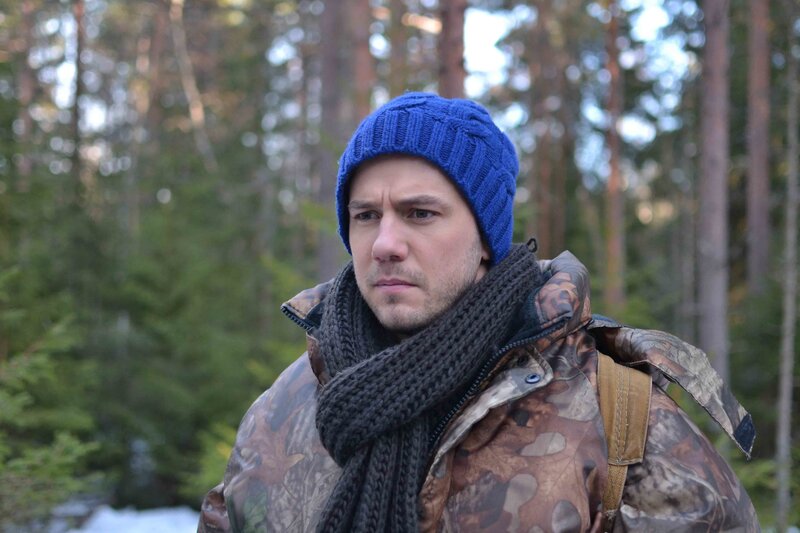 man in forest wearing beanie